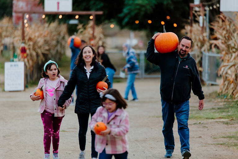 Family Carrying Pumpkins
